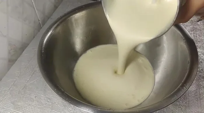 Grind the soaked dal and rice with some water into a batter.