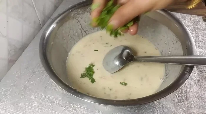 Mix well and add more water if needed to adjust the consistency. Add green coriander.
