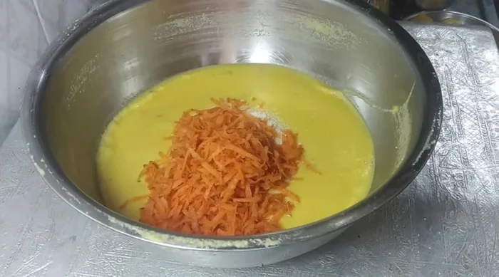 (Optional) For a vegetable version: Add semolina, grated carrot, chopped onion, capsicum, green coriander, and salt to the batter. Mix well. Add lemon juice (optional).