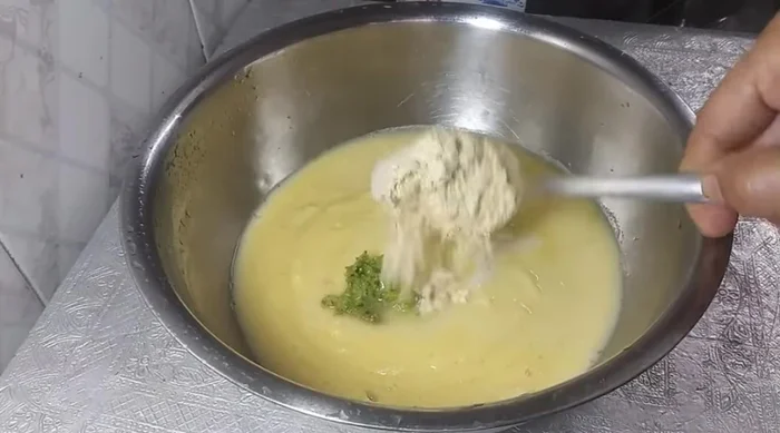 Add ginger-chilli paste, 1 spoon gram flour, salt, turmeric powder, asafoetida, and cumin seeds to the paste. Mix well to form a batter of desired consistency (neither too thick nor too thin).