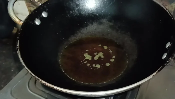 Heat mustard oil (or refined oil) in a frying pan. Fry the fish pieces until golden brown and crispy on both sides.