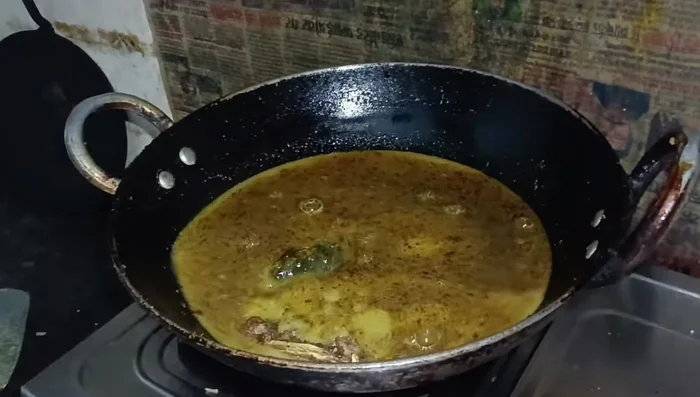 Add the fried fish to the gravy. Mix gently. Simmer for a few minutes to allow the flavors to blend.