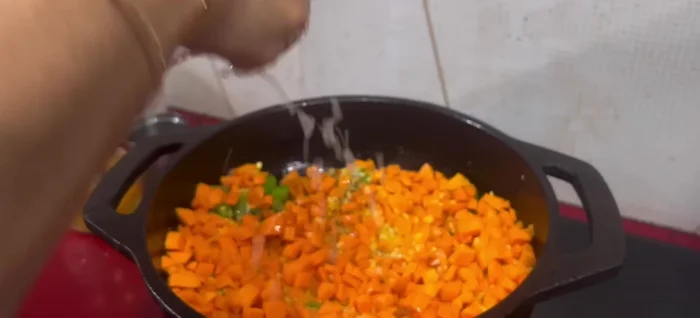 Add some of the moong dal soaking water and curry leaves. Cover and simmer until the dal and carrots are cooked.
