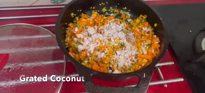 Once cooked, remove from heat and garnish with grated coconut.