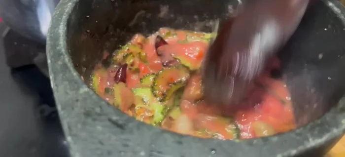 Add blended tomato puree, turmeric powder, hing, Kashmiri chili powder, and dhania powder. Mix well.