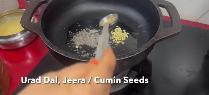 For Carrot Poriyal: Saute mustard seeds, urad dal, jeera, chana dal, hing, and green chilies in oil.