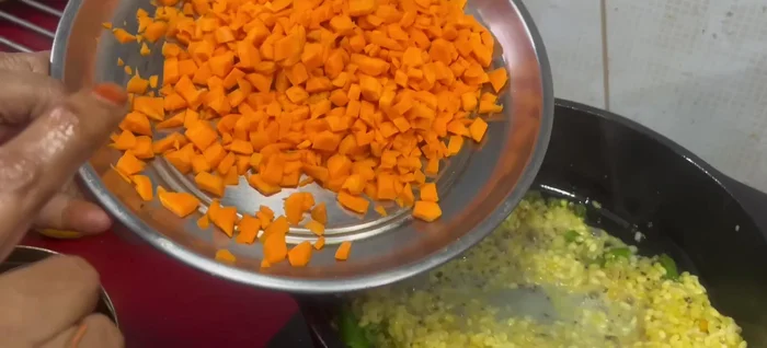 Add soaked moong dal, carrots, turmeric powder, and salt.