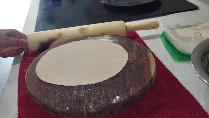 Prepare the dough by mixing flour and water to a soft, pliable consistency. Knead well. (Note: The quality of the dough significantly impacts the roti's softness)