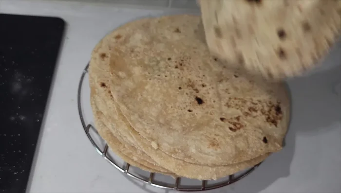 Remove the roti from the pan. Apply ghee (optional).