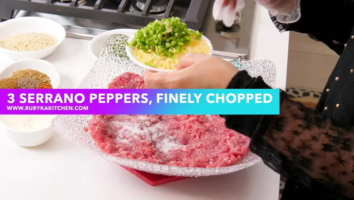 Marinate the mutton mince with salt, green chilies, garlic, ginger, chopped onion, green coriander, roasted crushed coriander, cumin, red chili powder, crushed chilies, and black pepper.