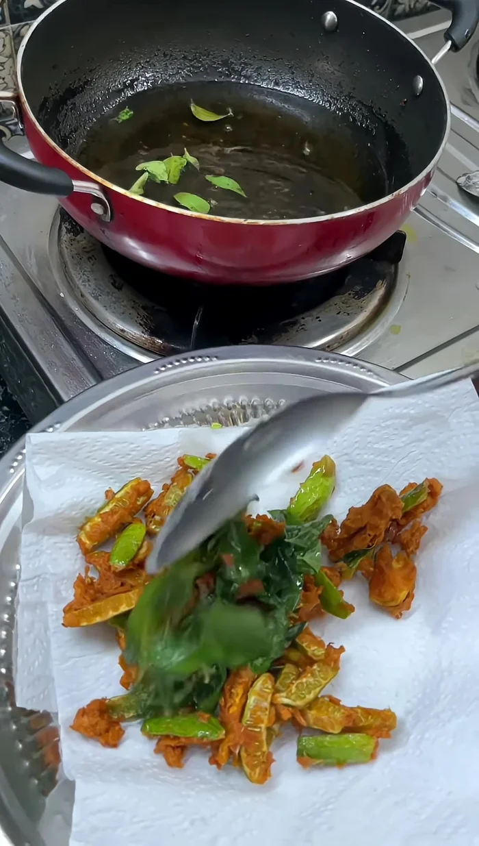 Add the fried seafood and green curry leaves to the fried Govakkai.