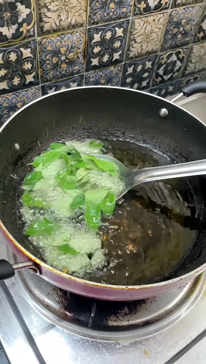Fry the green curry leaves in the remaining oil.