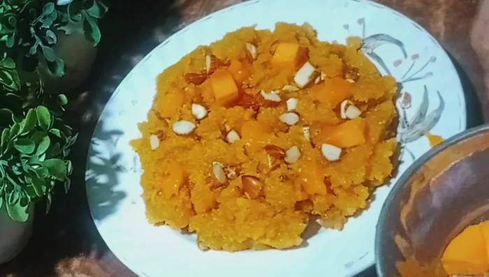 Garnish with remaining dry fruits and mango slices.