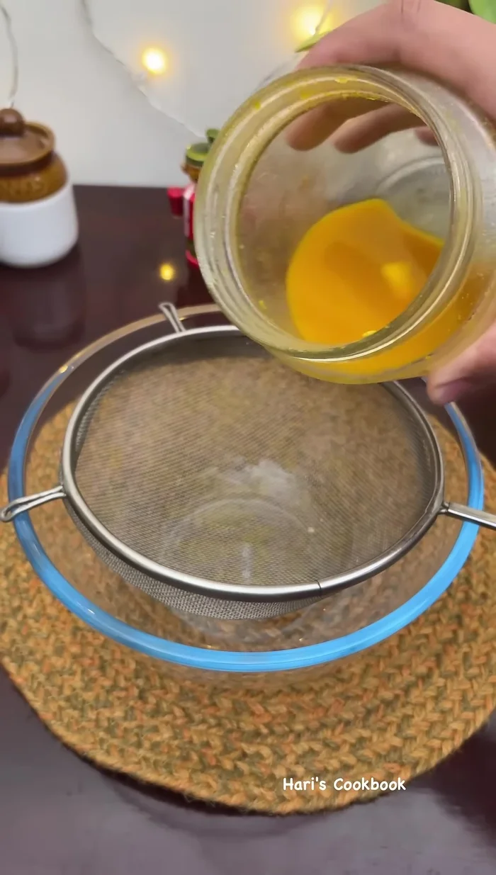 Filter the stored juice (from step 3). Add three-quarters of the dried mango pieces to this juice.