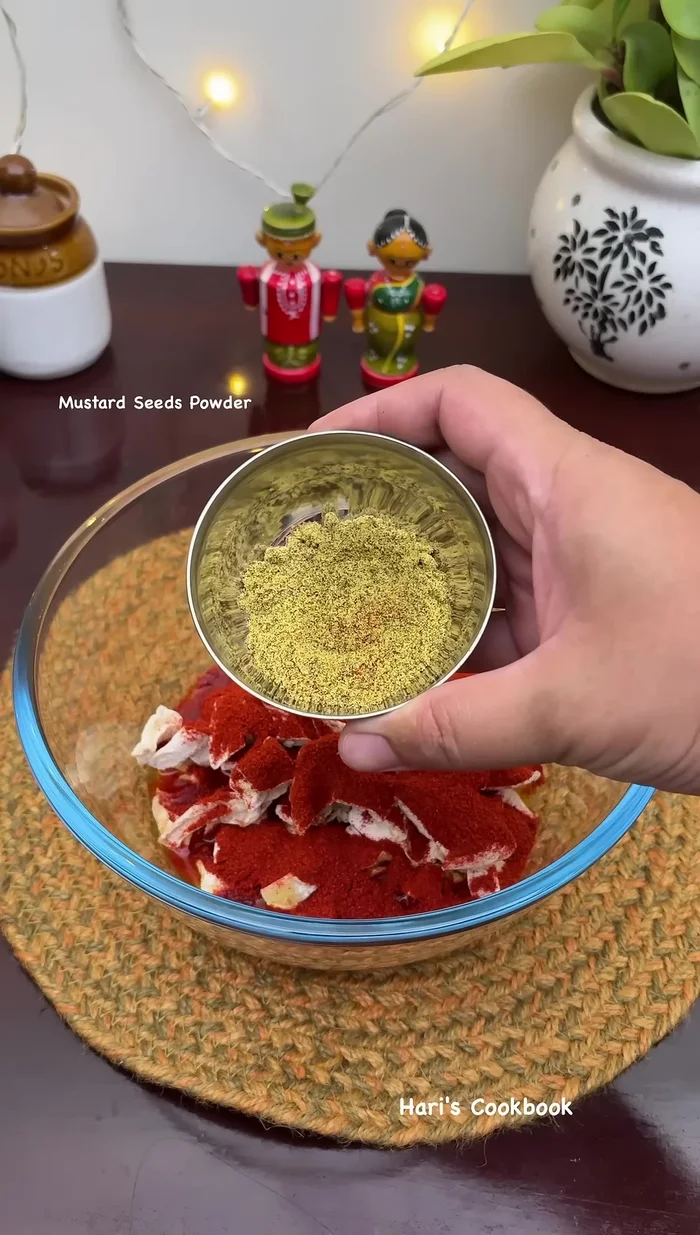 Add half a can of chili powder, two tablespoons of mustard powder, and one tablespoon of fenugreek powder. Mix well.