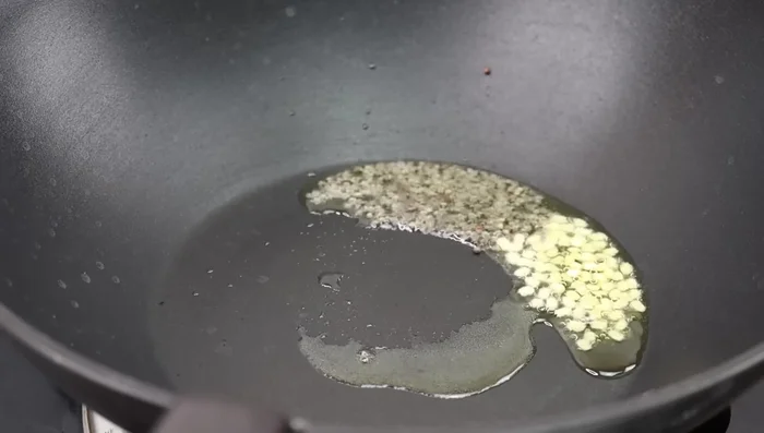 Add dried red chilies and asafoetida powder. Fry until fragrant.
