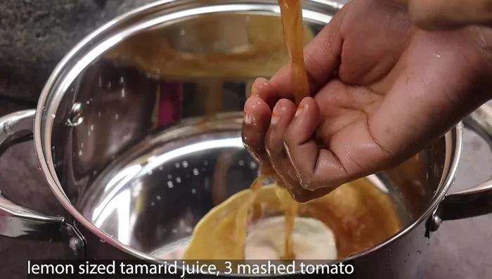 Soak tamarind in 1 cup of water for 30 minutes. After that, extract the juice and strain it.